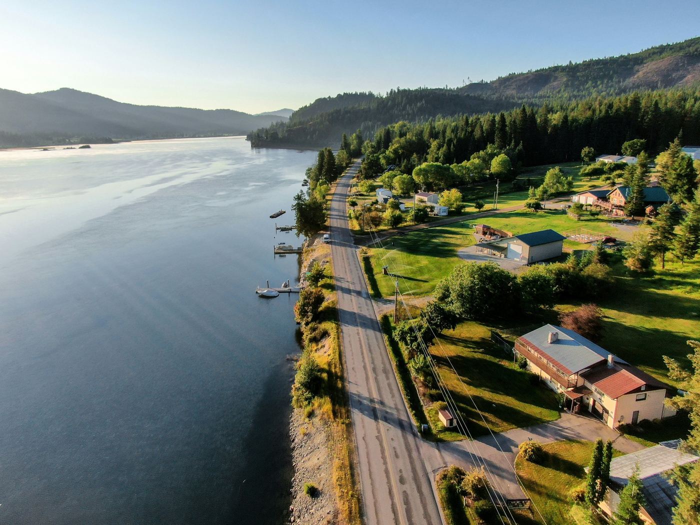 Aerial view of lakefront homes and private docks along a North Idaho shoreline